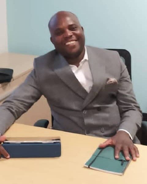 Ndaba Chiwara, Chairman of AEEWF, seated at a desk