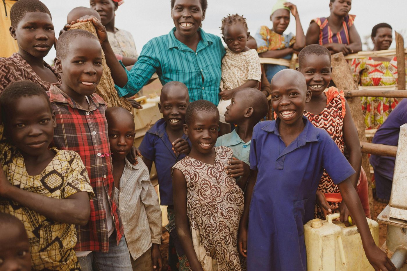 Children and families gathered at a community water point