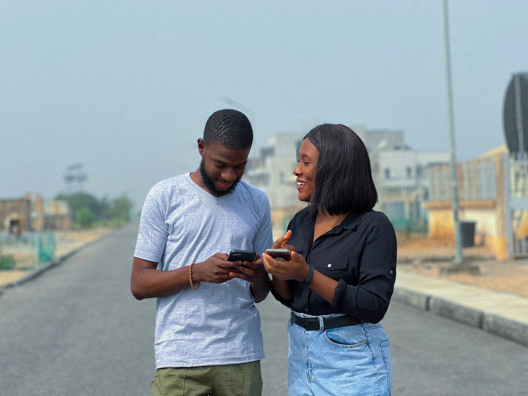 Young professionals sharing a document and laughing